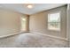 Bright bedroom with natural light, carpet flooring, and access to an outdoor space via glass panel door at 1858 Belmore Se St, Smyrna, GA 30080
