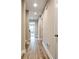 Hallway with hard wood flooring, neutral walls, and doorways to other rooms at 1858 Belmore Se St, Smyrna, GA 30080