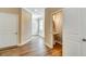 Hallway features hard wood floors, two closet doors, a powder room and entry at 1858 Belmore Se St, Smyrna, GA 30080