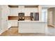 Stylish kitchen with white cabinets, stainless steel appliances, and island with quartz countertop at 1858 Belmore Se St, Smyrna, GA 30080