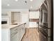 Modern kitchen boasts stainless steel appliances, white cabinets, and a sleek island with a sink at 1858 Belmore Se St, Smyrna, GA 30080