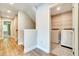 Convenient laundry room with a washer and dryer, shelving, and tile flooring for easy maintenance at 1858 Belmore Se St, Smyrna, GA 30080