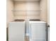 Modern laundry room featuring new front loading washer and dryer with tile floor and overhead rack at 1858 Belmore Se St, Smyrna, GA 30080