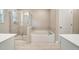Bright bathroom features a soaking tub, separate glass-enclosed shower, and tiled floor at 1858 Belmore Se St, Smyrna, GA 30080