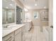 Elegant bathroom showcasing double vanities, tiled floors, a glass shower, and a soaking tub at 1858 Belmore Se St, Smyrna, GA 30080