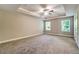 Large main bedroom features a tray ceiling, ceiling fan, and abundant natural light from two windows at 1858 Belmore Se St, Smyrna, GA 30080