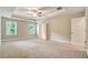 Large main bedroom featuring tray ceiling, ceiling fan, and double windows for natural light at 1858 Belmore Se St, Smyrna, GA 30080