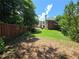 Large, fenced backyard with a lush lawn and mature trees, perfect for outdoor activities at 2670 Henderson Chase Ct, Tucker, GA 30084