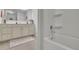 Modern bathroom vanity, tub, and neutral color scheme with geometric rug at 3940 Frasier Dr, Cumming, GA 30028