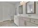 Elegant bathroom with double sink vanity, framed mirrors, and stylish fixtures at 3940 Frasier Dr, Cumming, GA 30028
