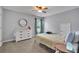 Bright bedroom featuring a round mirror, white dresser, and carpeted floors at 3940 Frasier Dr, Cumming, GA 30028