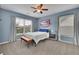 Comfortable bedroom featuring carpeted floors, ceiling fan, and lots of natural light at 3940 Frasier Dr, Cumming, GA 30028