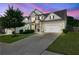 Stunning two-story home showcases a pristine lawn, two-car garage and picturesque dusk sky at 3940 Frasier Dr, Cumming, GA 30028