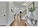 Spacious foyer with hardwood floors, elegant lighting, and staircase leading to the upper level at 3940 Frasier Dr, Cumming, GA 30028