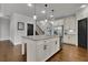 Open-concept kitchen features an island with granite countertops and stainless steel appliances at 3940 Frasier Dr, Cumming, GA 30028