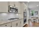 A kitchen features stainless steel appliances, white cabinets, granite countertops, and a breakfast area at 3940 Frasier Dr, Cumming, GA 30028