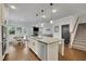 Bright, open kitchen with a large island, stainless steel appliances, and hardwood floors at 3940 Frasier Dr, Cumming, GA 30028