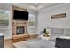 Cozy living room features a stone fireplace, and large windows for natural light at 3940 Frasier Dr, Cumming, GA 30028