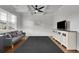 Bright living room featuring hardwood floors, a modern ceiling fan, and stylish furniture at 3940 Frasier Dr, Cumming, GA 30028