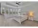 Tranquil main bedroom with tray ceilings, large windows, and a sitting area at 3940 Frasier Dr, Cumming, GA 30028