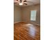 Comfortable bedroom with hardwood floors, ceiling fan, and bright window for natural light at 519 Roy Sw St, Atlanta, GA 30310
