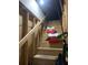 Unfinished wooden stairs lead upwards, illuminated by a bare bulb at 519 Roy Sw St, Atlanta, GA 30310