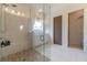 Stunning bathroom showcasing a glass shower, pebble floor, marble tiles, and double vanity at 5960 Overlook Club Cir, Suwanee, GA 30024