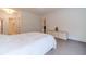 Bedroom with clean white walls, wood floors, and a cozy bed at 5960 Overlook Club Cir, Suwanee, GA 30024