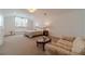 Bright bedroom features a sitting area, plush carpet, and ample natural light at 5960 Overlook Club Cir, Suwanee, GA 30024