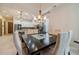 Bright dining room featuring a modern chandelier, large dark table, and an open layout to the kitchen at 5960 Overlook Club Cir, Suwanee, GA 30024