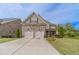 Charming two-story home with a stone and siding facade, two-car garage, and well-manicured lawn at 5960 Overlook Club Cir, Suwanee, GA 30024