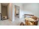 Upstairs hallway featuring a sitting area and a view of a bedroom at 5960 Overlook Club Cir, Suwanee, GA 30024