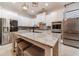 This kitchen boasts a large island with seating, stainless steel appliances and stylish pendant lighting at 5960 Overlook Club Cir, Suwanee, GA 30024