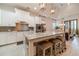 Bright kitchen with an island with seating and stainless steel appliances, open to the dining area at 5960 Overlook Club Cir, Suwanee, GA 30024
