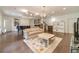 Spacious living room features hardwood floors, a grand piano, and a cozy seating arrangement at 5960 Overlook Club Cir, Suwanee, GA 30024