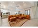 Open-concept living room with hardwood floors, recessed lighting, and an oversized sofa with decorative pillows at 5960 Overlook Club Cir, Suwanee, GA 30024