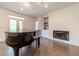Bright living room with fireplace, hardwood floors and piano at 5960 Overlook Club Cir, Suwanee, GA 30024