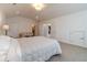 Bright main bedroom featuring plush carpet, access to bedroom, and vaulted ceilings at 5960 Overlook Club Cir, Suwanee, GA 30024