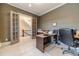 Bright home office features custom built-ins, a spacious desk, and french doors to the hallway at 5960 Overlook Club Cir, Suwanee, GA 30024