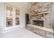 Covered patio featuring tiled floor, stone fireplace, and access to other parts of the house at 5960 Overlook Club Cir, Suwanee, GA 30024