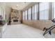 Covered patio featuring tiled floor, stone fireplace, and many windows at 5960 Overlook Club Cir, Suwanee, GA 30024