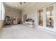 Sunroom featuring tiled floor, access to other parts of the house, and many windows at 5960 Overlook Club Cir, Suwanee, GA 30024