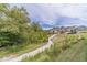 Scenic walking path through the community, with lush landscaping and beautiful homes in the background at 5960 Overlook Club Cir, Suwanee, GA 30024