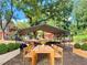 Backyard featuring a metal canopy, flower boxes, and a wooden dining table at 2039 Gober Ave Se, Smyrna, GA 30080
