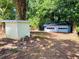 Backyard features a detached two-car garage, storage shed, and mature trees at 2039 Gober Ave Se, Smyrna, GA 30080