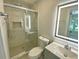 Contemporary bathroom with a glass shower, gray vanity, and an illuminated mirror at 2039 Gober Ave Se, Smyrna, GA 30080