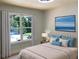 Bedroom featuring a queen-size bed, large window, and ocean themed wall art at 2039 Gober Ave Se, Smyrna, GA 30080