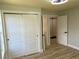 Bedroom with sliding door closets and view to an ensuite bathroom at 2039 Gober Ave Se, Smyrna, GA 30080