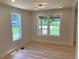 Bright dining space features large windows overlooking the front yard at 2039 Gober Ave Se, Smyrna, GA 30080