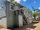 Renovated home with gray siding, a back staircase, and a garage with side entry at 2039 Gober Ave Se, Smyrna, GA 30080